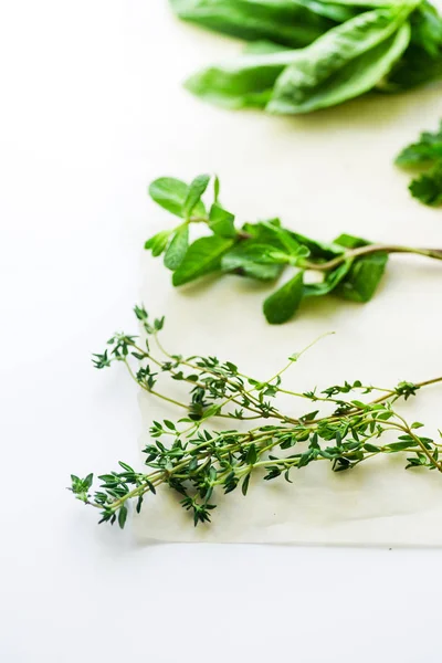 bunches of thyme and mint with basil herbs isolated on white background, close-up