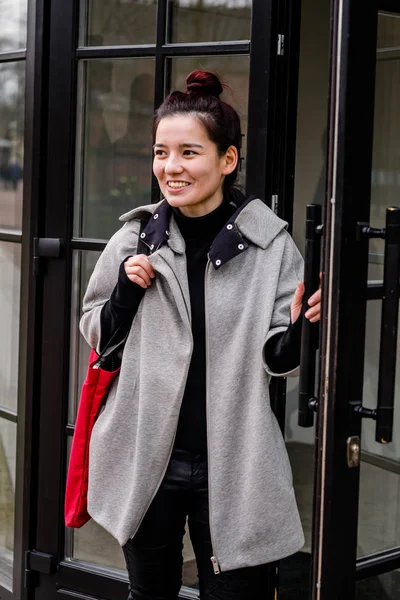 Image Young Asian Model Dressed Gray Coat Opening Glass Door — Stock Photo, Image