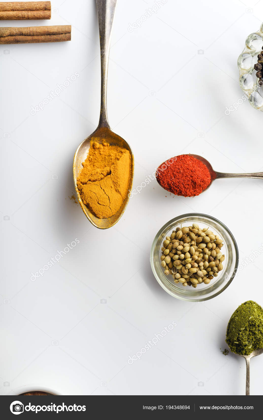 Assortment Of Colorful Spices In The Wooden Spoons On The White