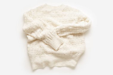  Warm knitted sweater on white background. Minimalistic flat lay                              