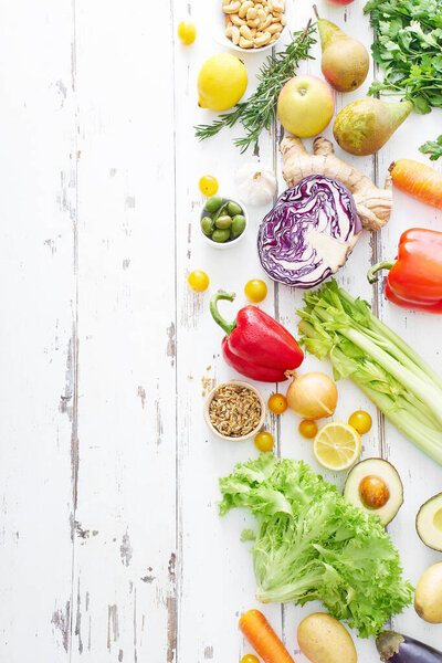 healthy raw organic vegetables with herbs and sprouts with fruits on white wooden table. Fresh garden vegetarian food concept 