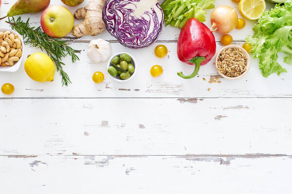 healthy raw organic vegetables with herbs and sprouts with fruits on white wooden table. Fresh garden vegetarian food concept 