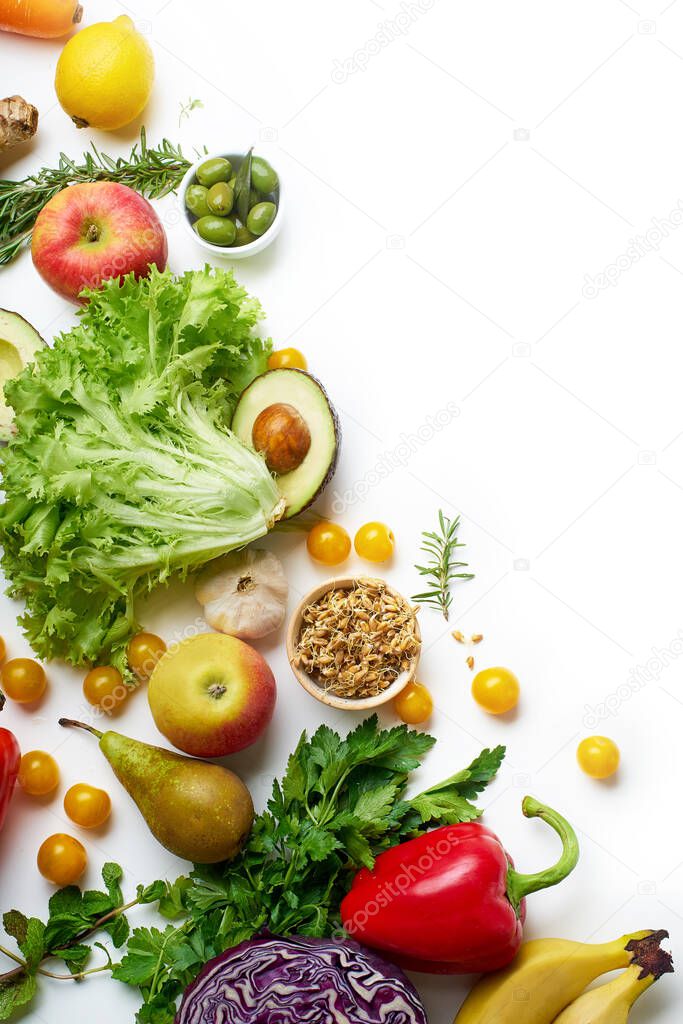 healthy raw organic vegetables with herbs and sprouts with fruits on white wooden table. Fresh garden vegetarian food concept 