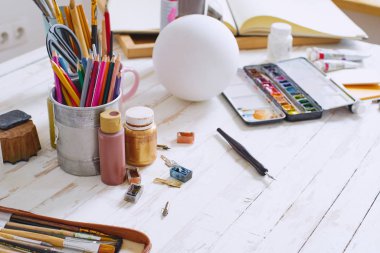 Alçıtaşı şekilli, kurşun kalemli fırçalı ve masa üzerinde boya şişeleri olan serbest ressamların stüdyosunun içi. Serbest sanatçı yaşam tarzı konsepti 