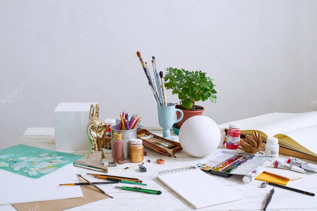 Workspace of designer illustrator with materials and equipment 