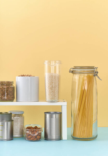 Food staples on pantry shelf prepared to survive Coronavirus COVID 19 pandemic at the time of quarantine and home isolation 