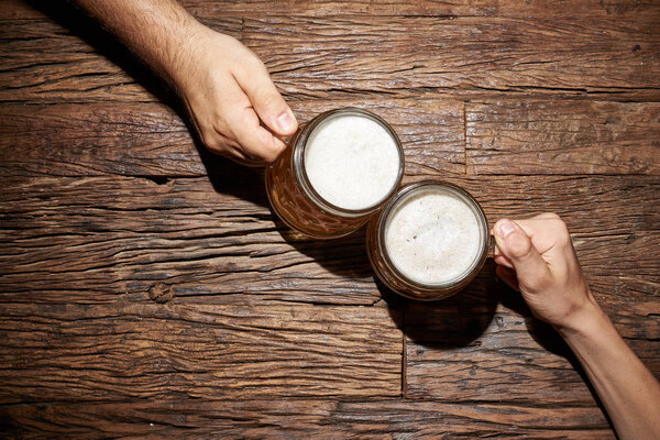 Hands with beer mug