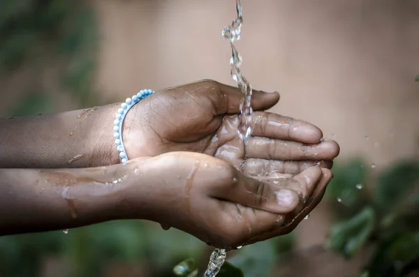 Handen nemen water uit de kraan — Stockfoto