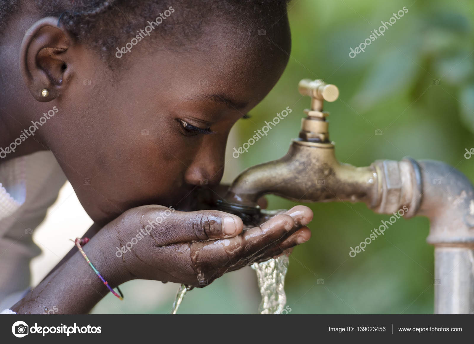 African boy drinking water from tap ⬇ Stock Photo, Image by