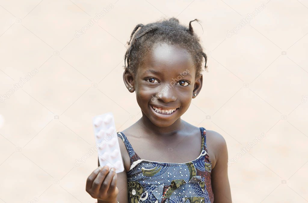 Young girl holding medicine in hand