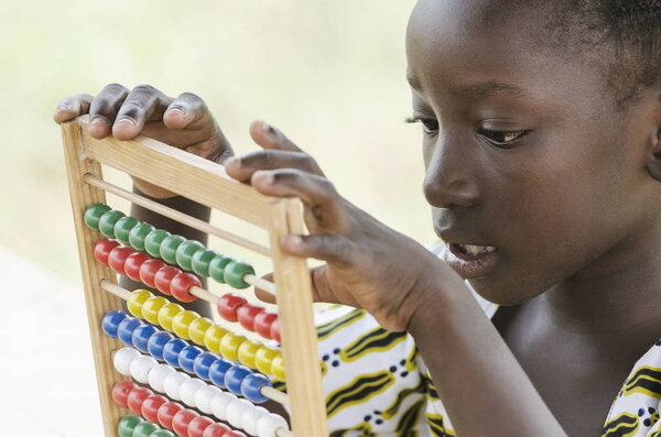 African girl counting on abacus