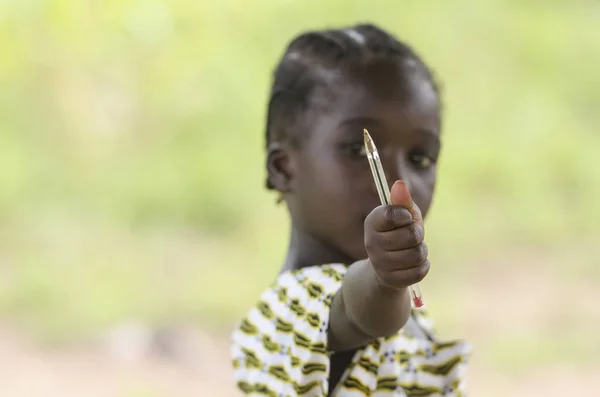 Young girl holding pen in hand — Stock Photo, Image