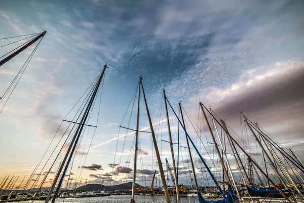 Boats masts in Alghero harbor at sunset — Stock Photo, Image
