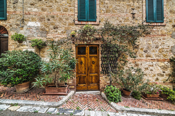 Wooden door in a rustic wall in Montecatini, Italy