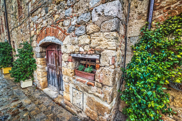 Old wooden door in Monteriggioni, Italy