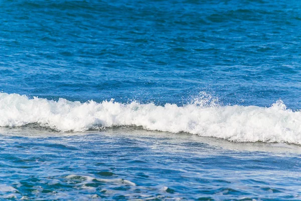 Witte golf en blauwe zee — Stockfoto