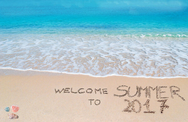 welcome to summer 2017 written on a tropical beach