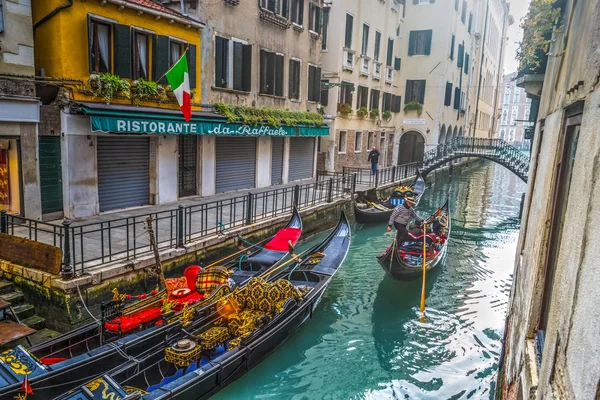 Gondolero con turistas en un pequeño canal de Venecia — Foto de Stock