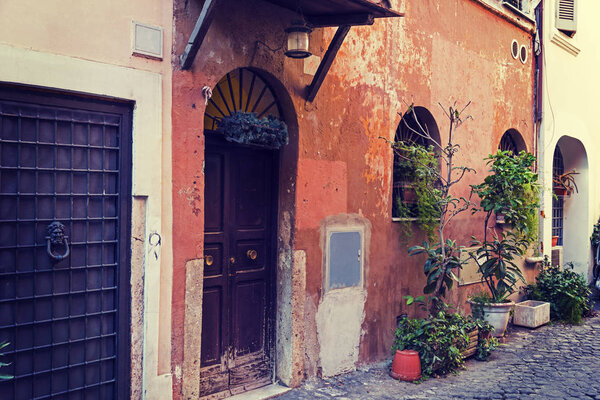 Rustic door in a picturesque alley in Trastevere. Rome, Italy