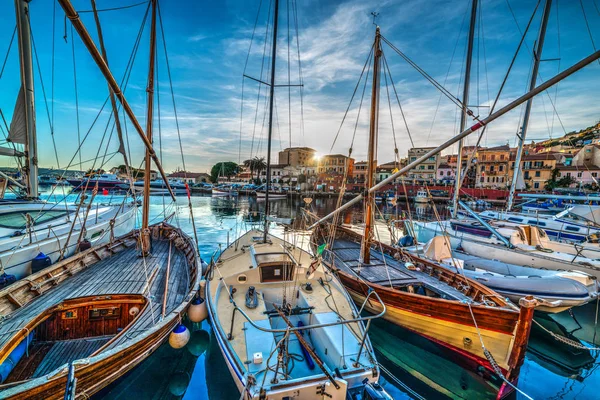 Wooden boats in La Maddalena harbor at sunset — Stock Photo, Image