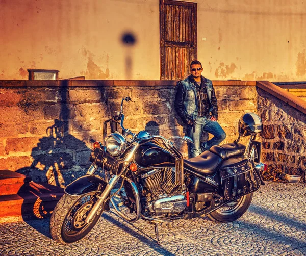 Biker und klassisches Motorrad bei Sonnenuntergang — Stockfoto