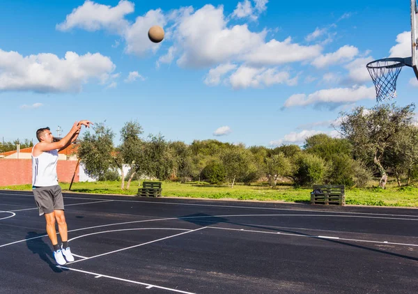 Basketballspieler springt auf Spielplatz — Stockfoto
