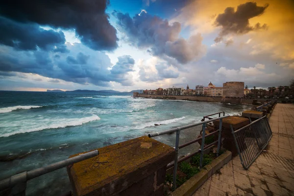 Dark clouds over Alghero at sunset — Stock Photo, Image