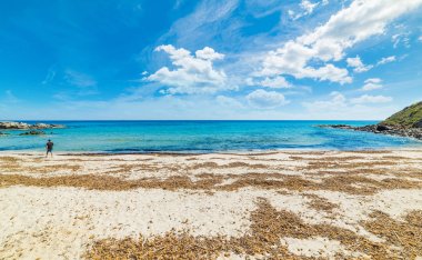 Santa Giusta plaj kum üzerinde yürüyen adam