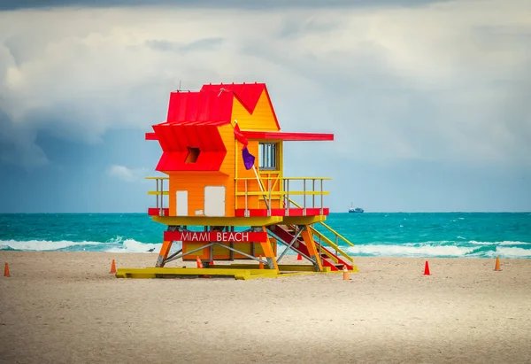 Red and Orange lifeguard hut in South Beach on a cloudy sky. Miami Beach, USA