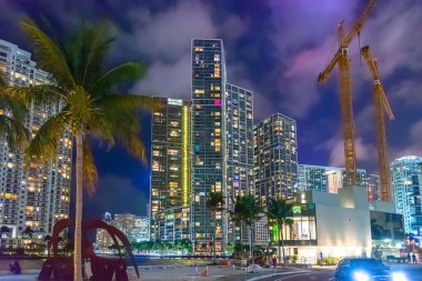 Geceleri Miami Riverwalk 'ta bulutlu bir gökyüzünün altında gökdelenler. Florida, ABD