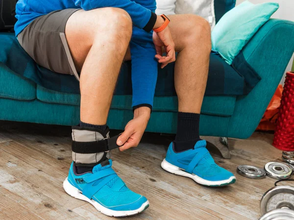 Man Closing Velcro Strap Ankle Weight Home Workout — Stock Photo, Image