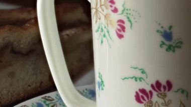 Güzel Kupası çiçek ve tatlı bir parça boyalı