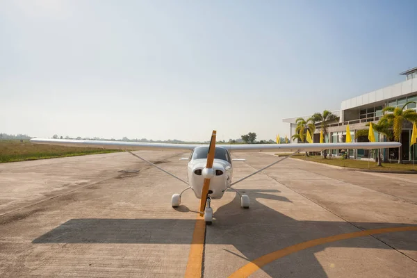 Small airplane with propeller in front parking on runway and preparing to fly.