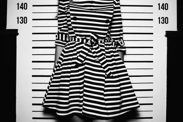 Young woman in dress with line standing like for police photo — Stock Photo, Image