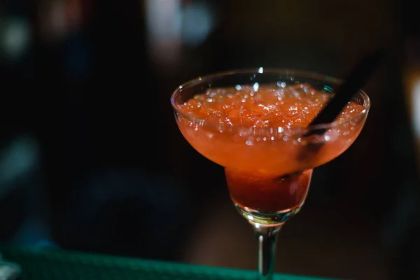 Alcohol bar, cocktail glass on bar counter, cocktail glass in a bar, Drinking cocktail in bar, cocktail in the glass with straws, Fresh drink coctail on a color background