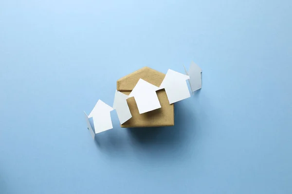 Paper house model on blue background. Real estate concept