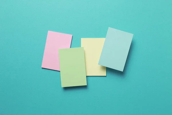 Colorful memo pad, sticky notes on mint background