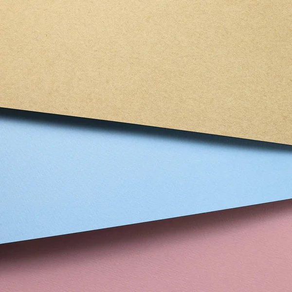 Brown kraft and blue paper and pink paper sheet overlapping background — 스톡 사진