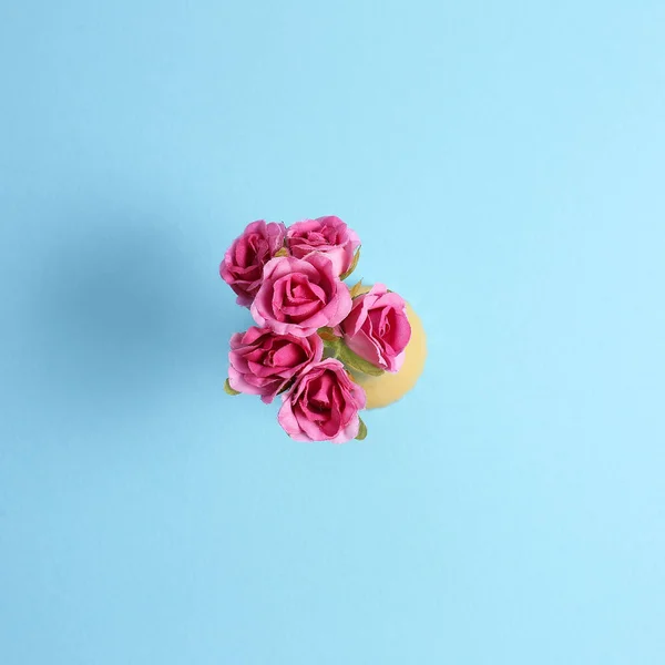 Pink flower bottle on blue background