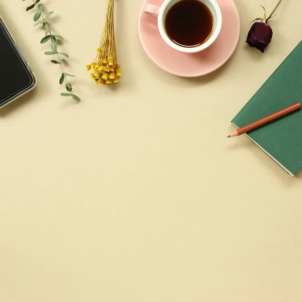 Work and study place. note book, cup of coffee, smart phone with floral decoration. flat lay, top view, copy space