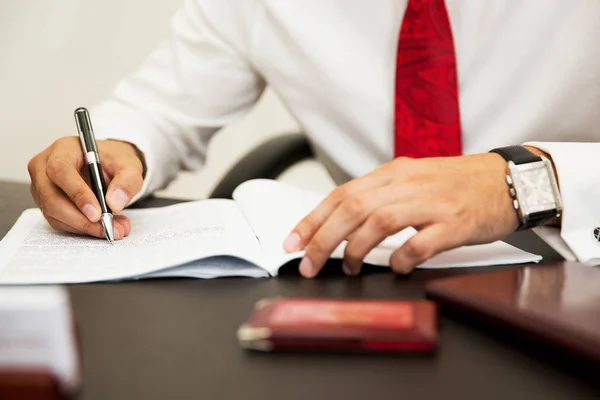 Folded hands on an agreement Stock Image