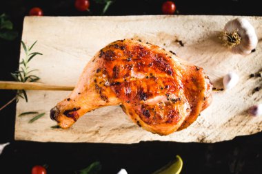 Tavuk kalça sarımsak biber yerleştirilmiş bir Ahşap doğrama kurulu ızgara.