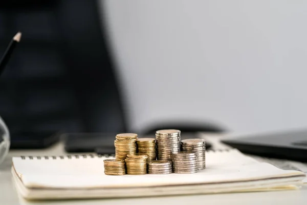 Silver and gold coins stacked on the work desk,Money for busines