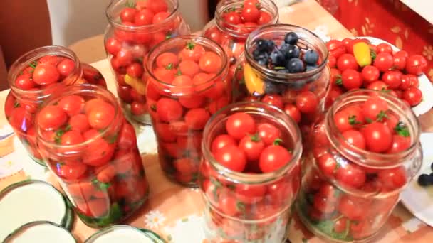 Cherry tomatoes in the jars prepared for preservation — Stock Video