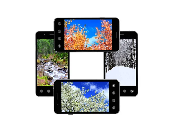 Modern mobile phones with images of four seasons — Stock Photo, Image