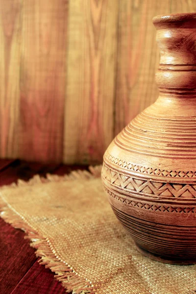 Decanter ceramic brown on the sacking. Old crockery — Stock Photo, Image