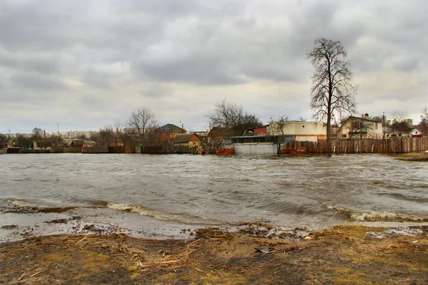 Flooding of river in spring in town during melting of snow. Natural disaster — Stock Photo, Image