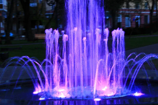 Blue fountains in city park. Colorful jets of water — Stock Photo, Image