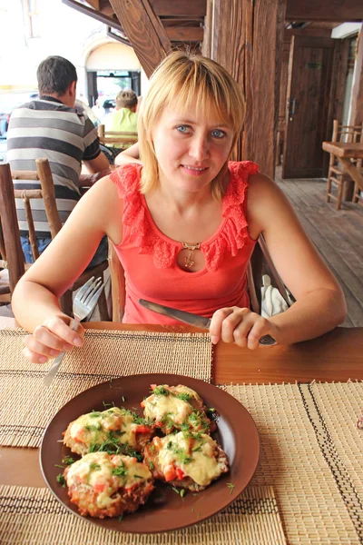 Belle femme mangeant un plat charnu au restaurant — Photo