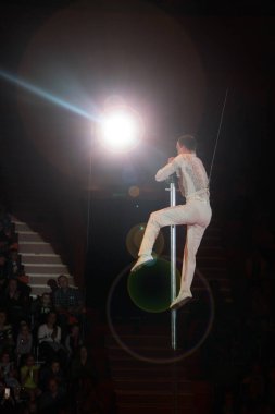 Gomel / Belarus - May 20, 2018 : gymnast of balancing actor performing number high above circus arena. Circus number. Man equilibrist showing tricks during performance of gymnasts in circus. Gymnasts equilibrists under circus dome
